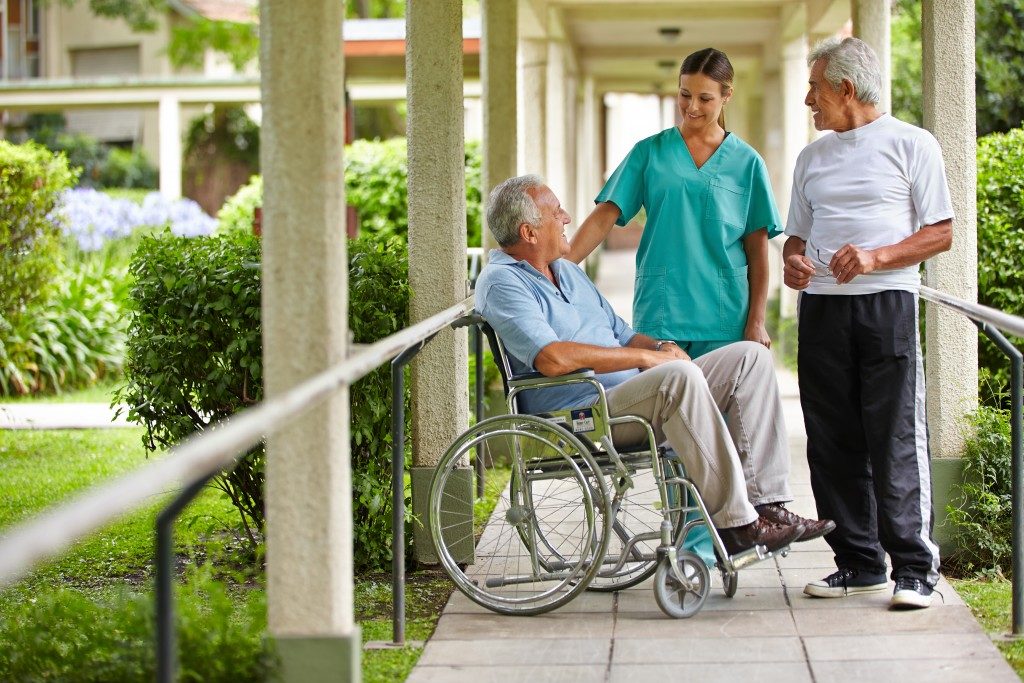 Senior citizens talking to a nurse