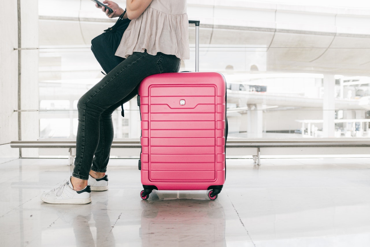 woman sitting on her luggage