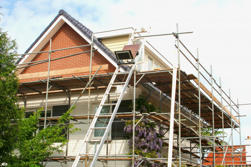 house being renovated with scaffoldings around