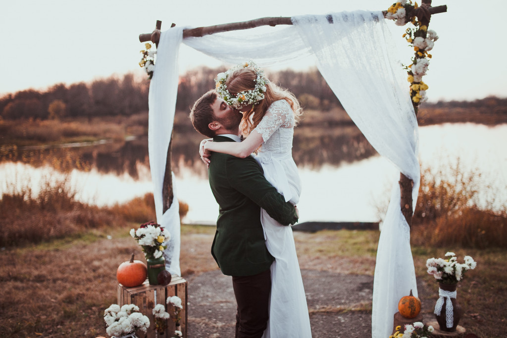 groom kissing his bride in altar